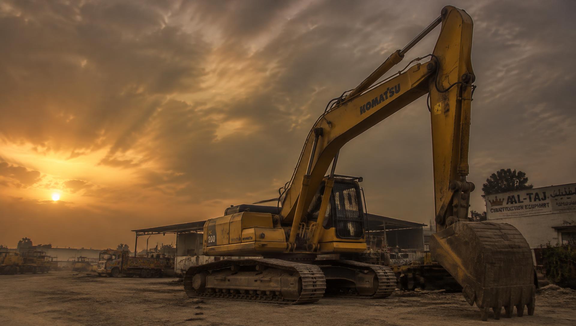 Excavator at a machinery yard at dusk
